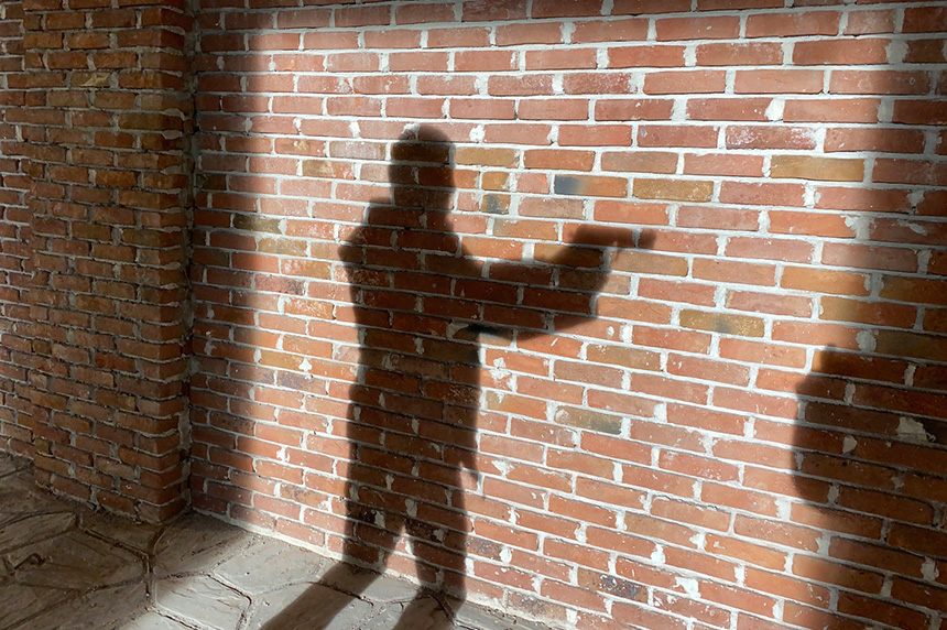 shadow of person holding gun 